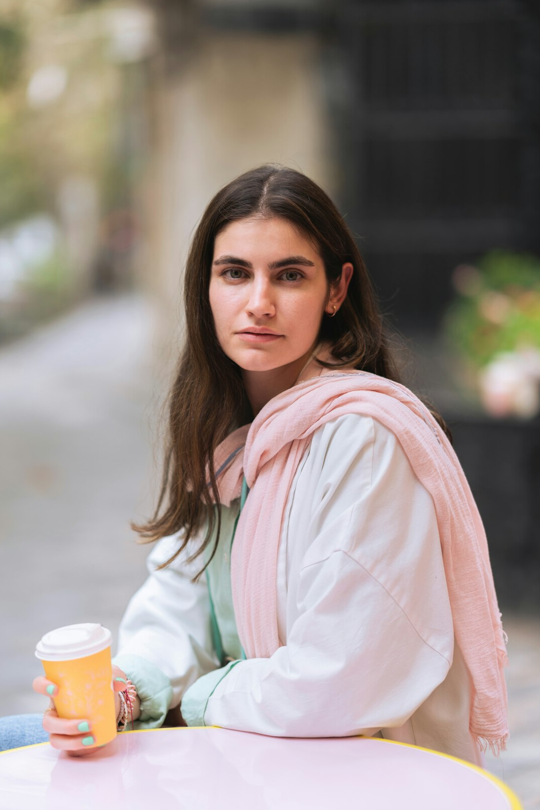 woman with coffee cup on street