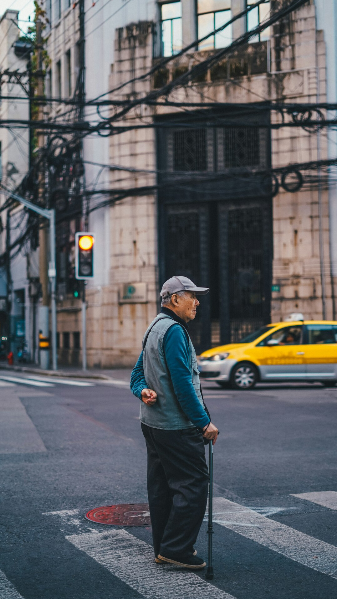 elderly man helping person cross street