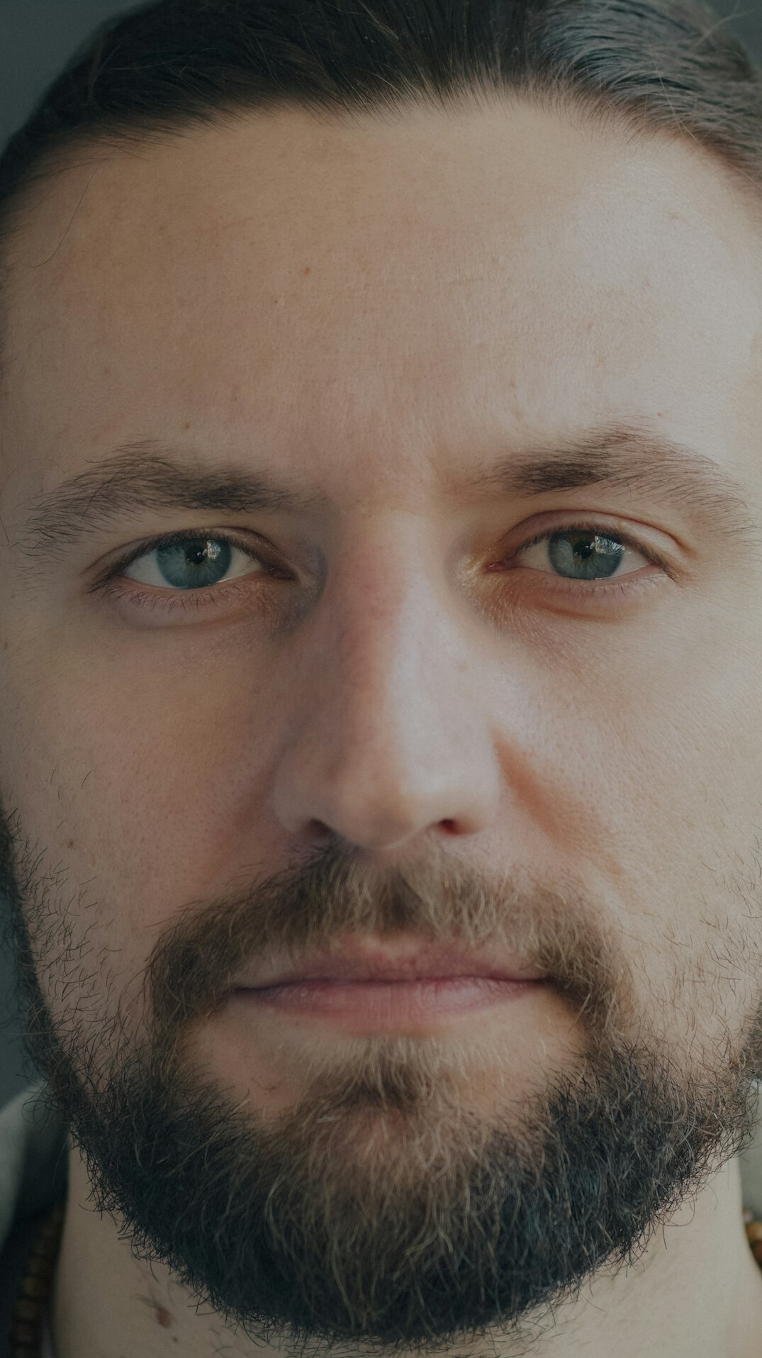 Studio portrait of a bearded man photographer looking at the camera
