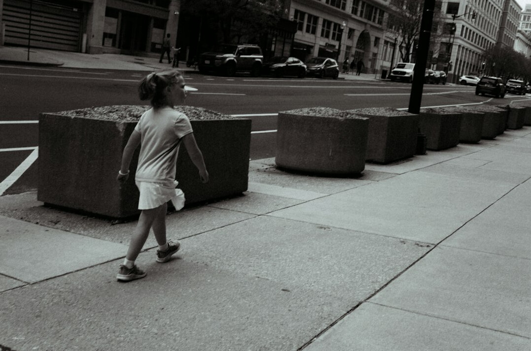 Portrait of a child playing on a city sidewalk