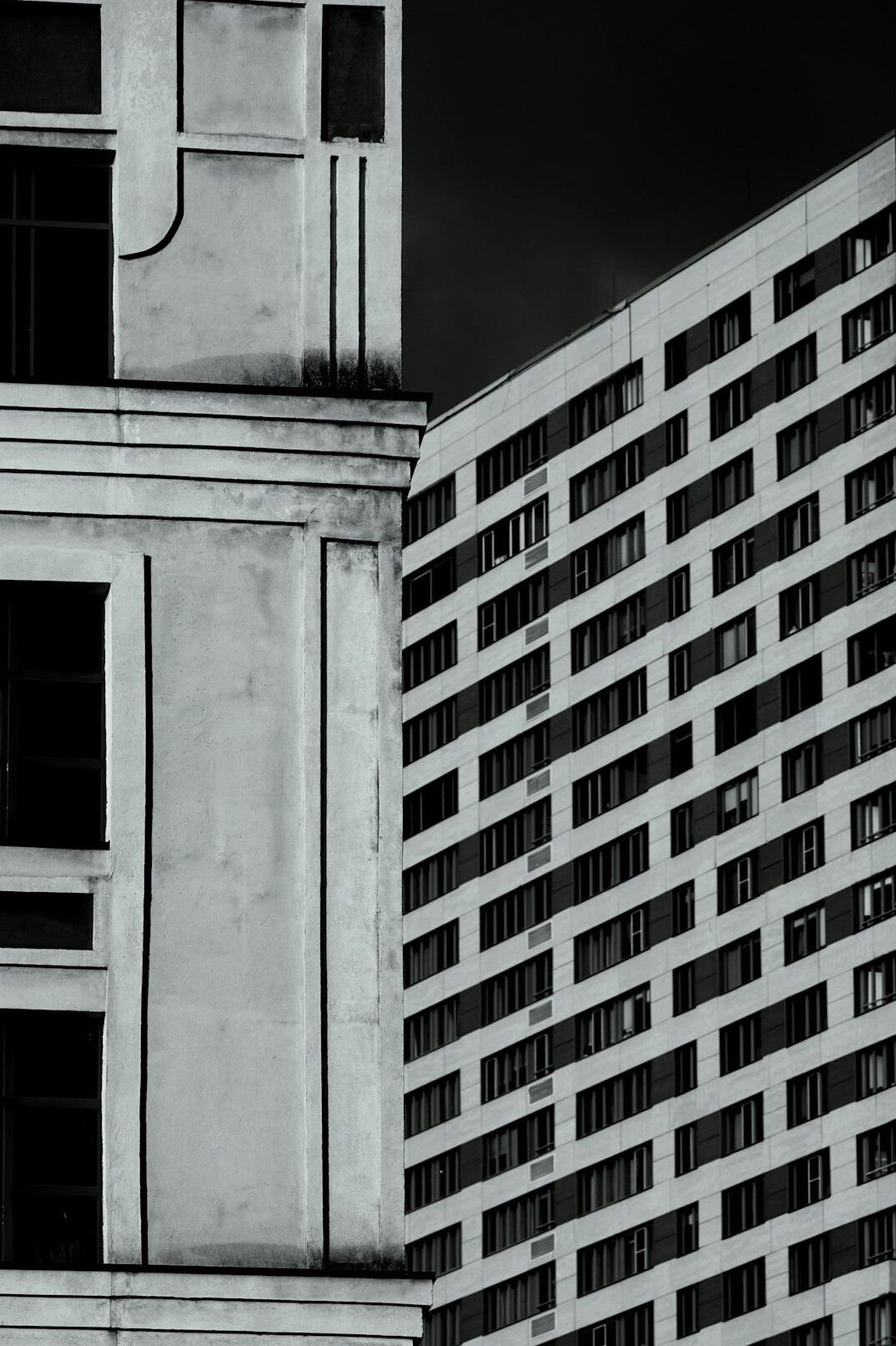 old building next to modern skyscraper